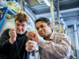 Scientist Pavan Manvi from RWTH Aachen University (right) and Covestro researcher Dr. Jochen Norwig holding a synthetic fiber prototype made from CO2.